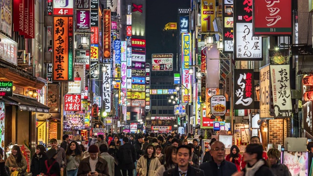 在日本东京新宿，一群人在购物霓虹街道和车流交叉人行道上行走的4K时间间隔。日本文化和城市生活理念视频素材