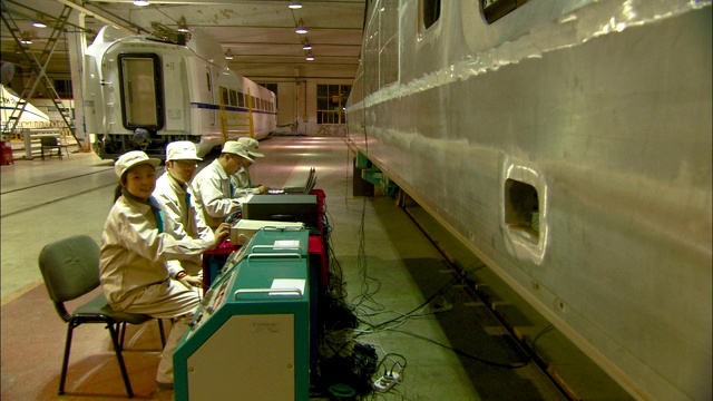技术人员为中国南方铁路的一列新列车安装电气连接。视频下载