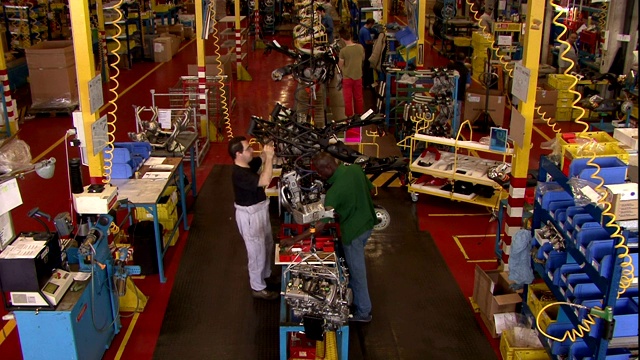 机械师在工厂组装摩托车车架。视频下载