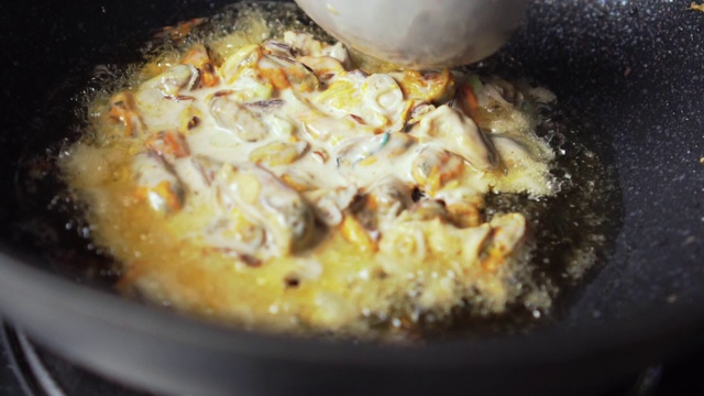用蛋糊煎贻贝制成的。亚洲食品。泰国菜。加入。缓慢的运动。视频素材