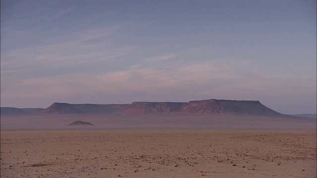 岩层和高原耸立在撒哈拉沙漠的贫瘠地区。视频下载