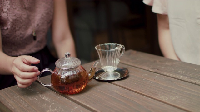在日本东京的餐馆里，木桌上的玻璃茶壶和杯子。视频下载