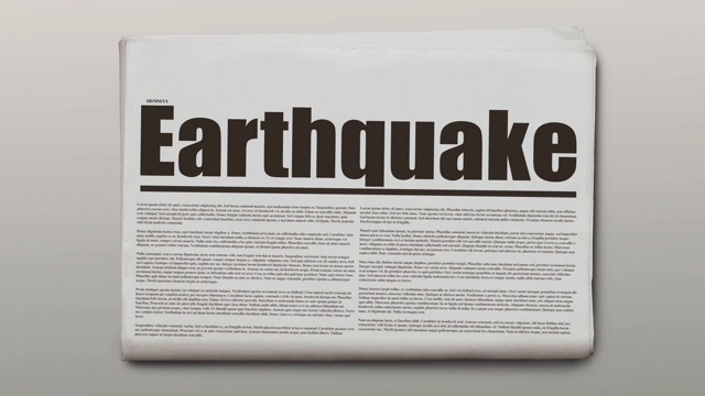 旋转报纸上的文字是地震。视频素材