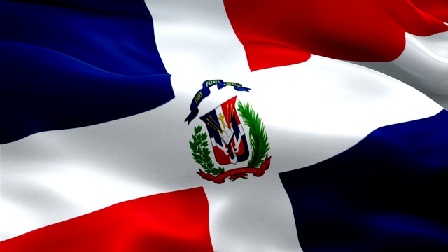 多米尼加共和国的旗帜在风中飘扬。现实的多米尼加共和国国旗背景。多米尼加共和国旗帜循环特写1080p全高清1920X1080镜头。多米尼加共和国南美国家国旗镜头视频电影，新闻视频素材