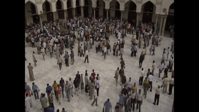 一群埃及人聚集在一座列有柱子的大楼里。视频下载