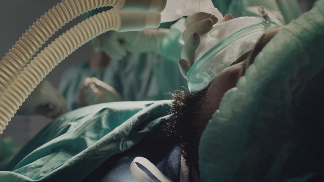 病人躺在床上，脸上戴着氧气面罩视频下载