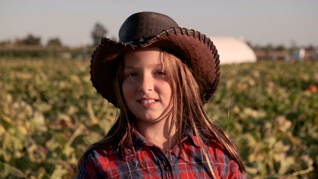 10岁的美国农家女孩戴着牛仔帽，微笑着看着摄像机视频下载