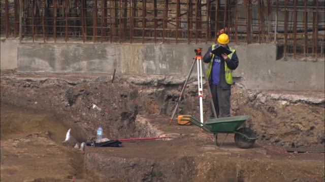 土地测量师在一处挖掘地点工作。视频素材