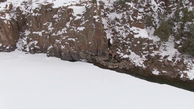 航拍:在多雪的科罗拉多州，两名游客正在温泉中游泳视频素材