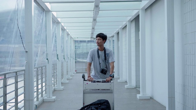 带着行李走过机场航站楼的亚洲潮人旅行者视频素材