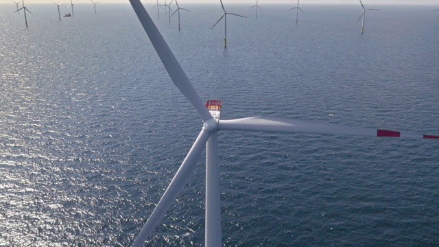空中风力涡轮机在海上在阳光下旋转视频素材