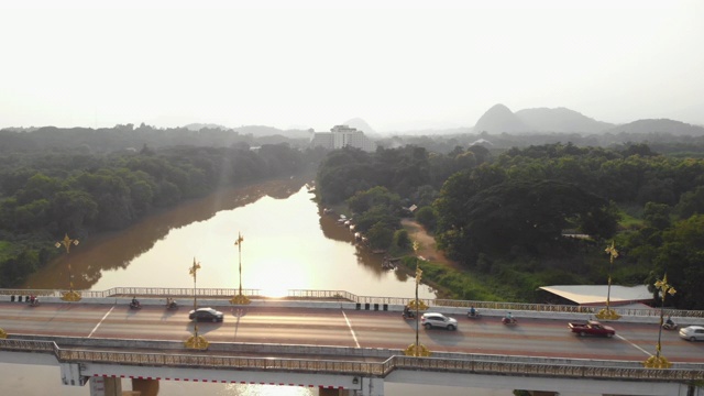 日落空中俯瞰拍摄，河桥，稳定拍摄，汽车，鸟瞰图的交通过桥，清莱，泰国，亚洲的公路桥，森林。阳光，早晨，东南亚，交通。视频素材