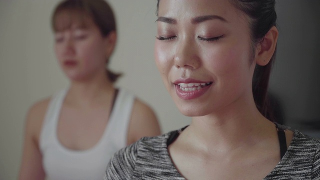 在瑜伽课上，一名千禧年的妇女正在用呼吸练习冥想视频素材