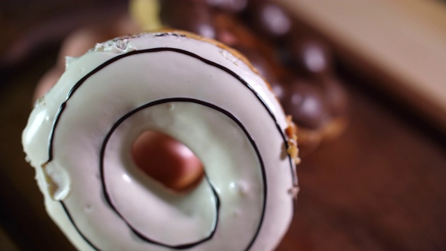 转向拍摄的甜甜圈在黑暗的背景视频素材