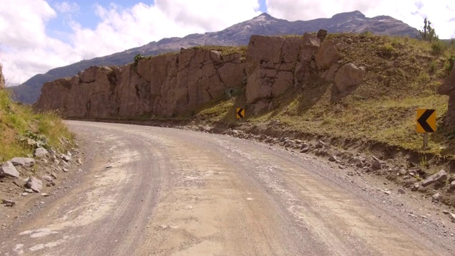 驱动板。汽车行驶在一条乡间小路上，土质、木槌山脉、山谷- POV -视角前方视频素材