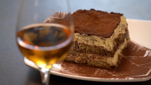 意大利提拉米苏搭配甜点酒——盘子被放在桌子上。视频下载