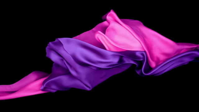 金属粉色和紫色的丝质面料在超慢的动作中横向流动和摆动，近距离，黑色背景视频素材