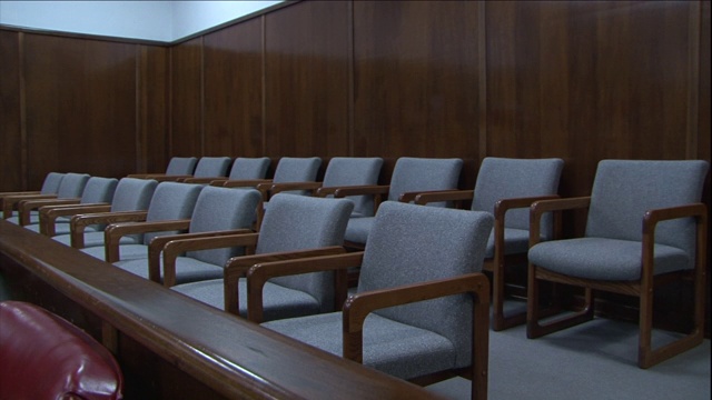 两排空椅子占据了一个法庭。视频下载