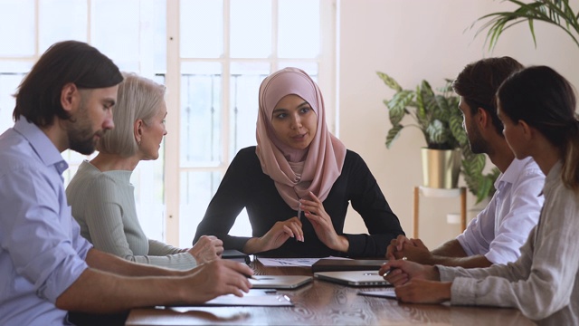 亚洲穆斯林女性公司领导在团队会议上讨论文书工作视频素材