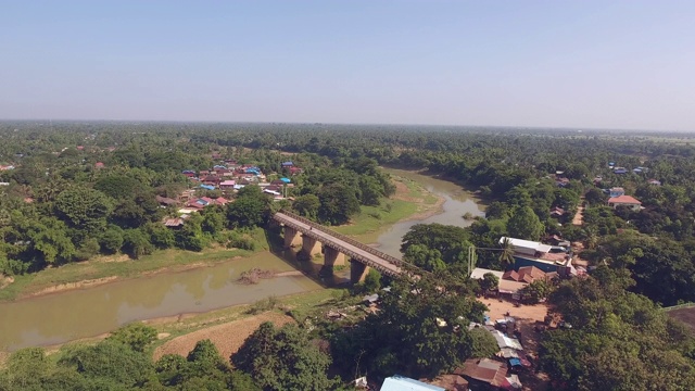 从连接两个小村庄的河上的旧桥撤退的鸟瞰图视频素材