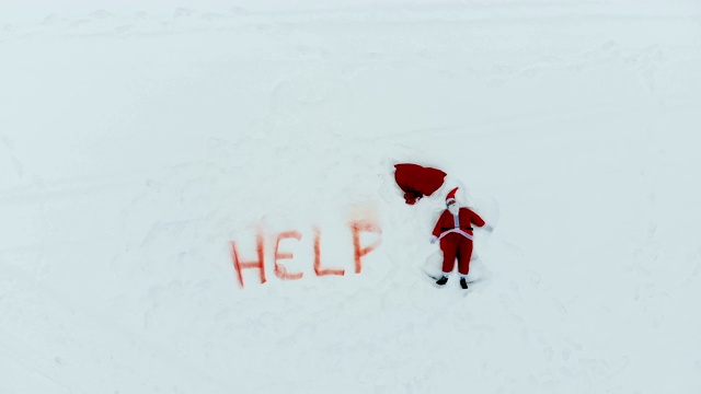 帮助'标志写在雪和圣诞老人做一个雪天使旁边视频下载