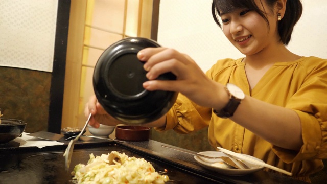在日式餐厅做御好烧的年轻女子视频素材