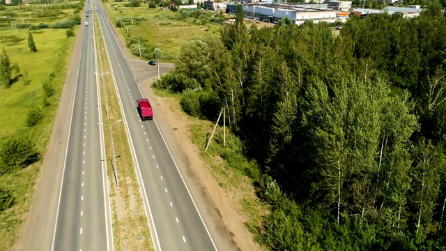 红色卡车沿着公路驶过现代的卡玛斯修理站视频素材