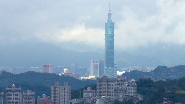 台湾一座摩天大楼高耸于周围的建筑物之上。视频素材