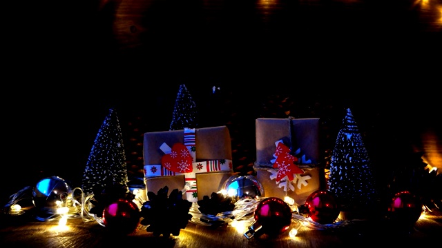 圣诞节和新年的背景与礼物。用牛皮纸包裹的礼物，上面有节日的标志——心形和冷杉树。视频下载