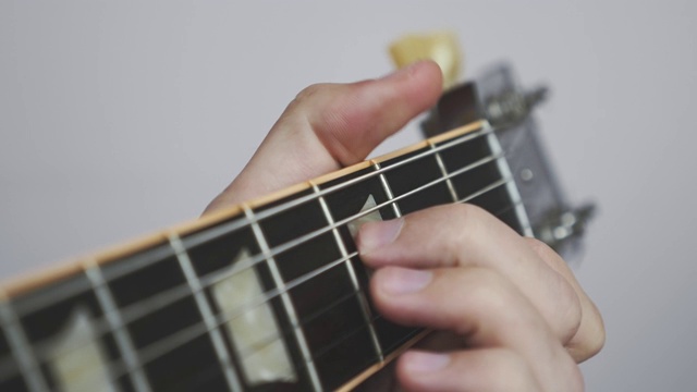 用吉他指板和床头箱弹奏和弦。吉他手用吉他演奏歌曲。视频素材