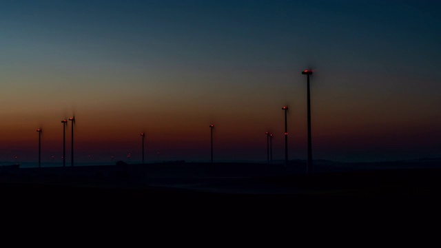 T/L从黎明到日出的时间流逝拍摄的风力涡轮机在农村旋转视频素材