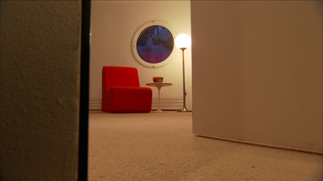 在沉睡者之家，红色的椅子为房间提供了一个圆形的窗户。视频下载