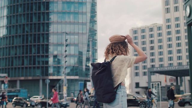 柏林市中心，背着背包戴着帽子的年轻女子视频下载