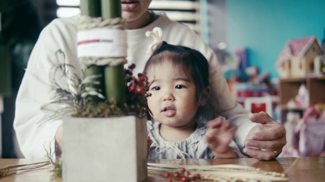 日本母亲和女儿制作除夕装饰(角松)视频素材