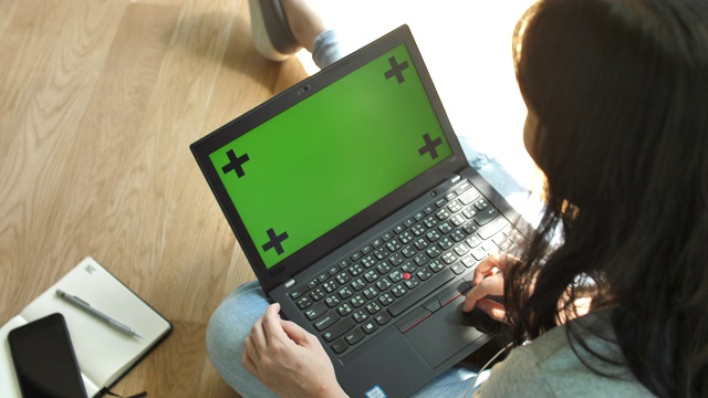 亚洲妇女工作打字和看着笔记本电脑的绿色屏幕视频素材
