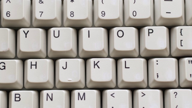男手指在白色键盘上按O键。慢镜头和宏观视角视频下载