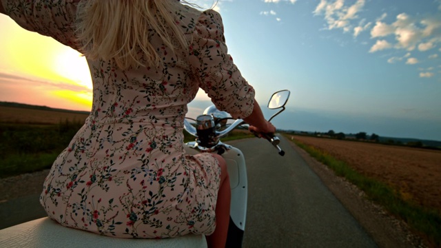 超级慢行的女人骑着摩托车在乡村公路上视频素材