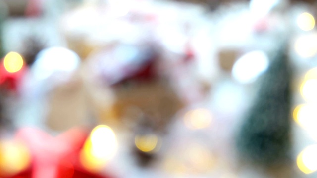 圣诞和新年的背景与礼物，丝带，球和不同的绿色装饰在木制的背景。视频下载