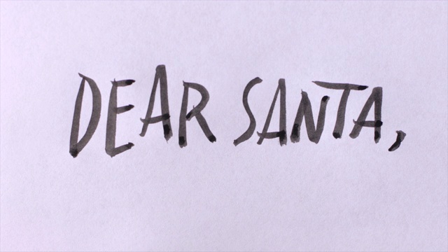 在白纸上用大写字母手写“亲爱的圣诞老人”视频素材