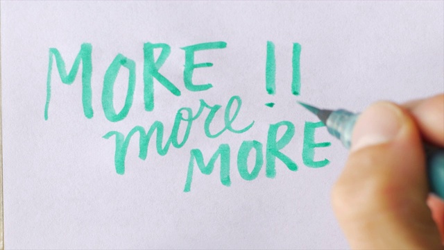 手写更多，更多，更多!!在白纸上用绿色的毛笔视频素材