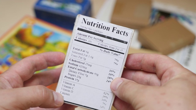 男性阅读含有营养和质量的食品标签视频下载