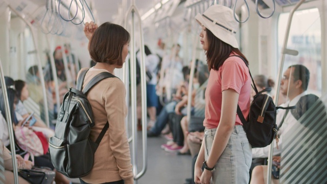两个女游客在火车上聊天，慢镜头视频素材