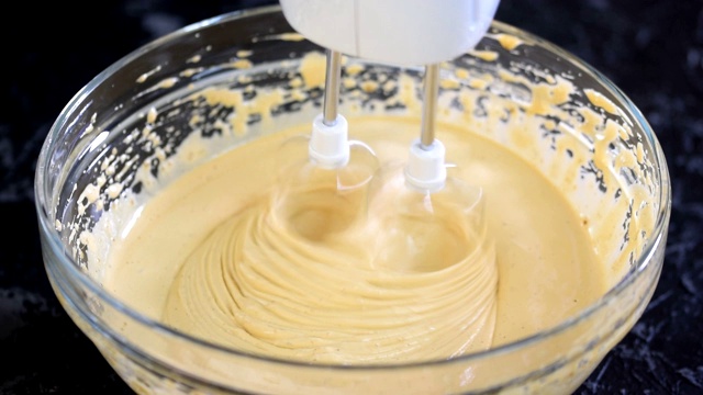 用电动搅拌机做蛋糕糊。视频素材