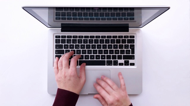 4K女人在笔记本电脑上打字的俯视图视频素材