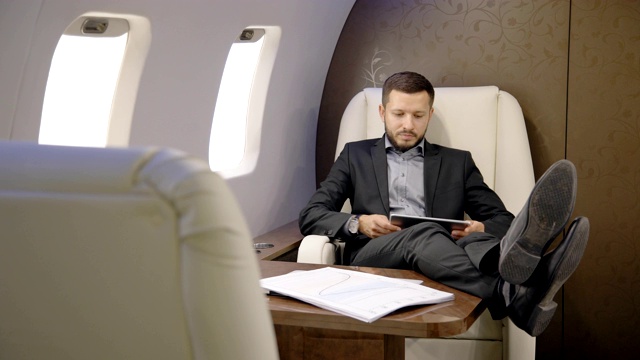在私人企业家飞机上放松的男性金融分析的肖像视频下载