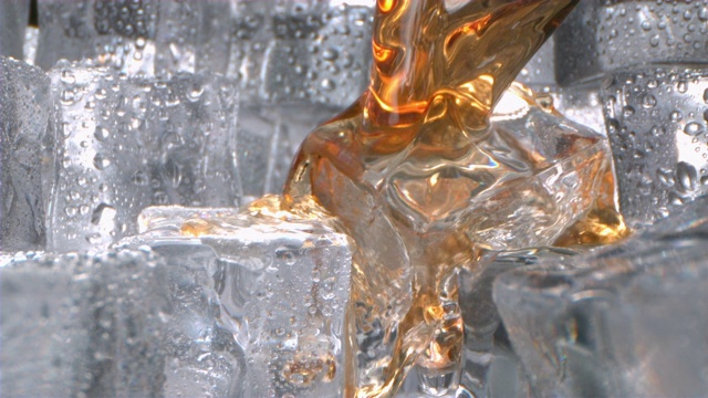 威士忌与冰倒入一个高速运动的玻璃杯视频下载