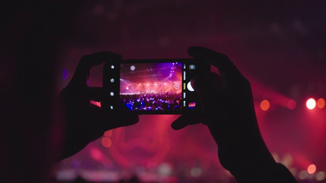 在音乐会上拿着智能手机的女人的手视频素材