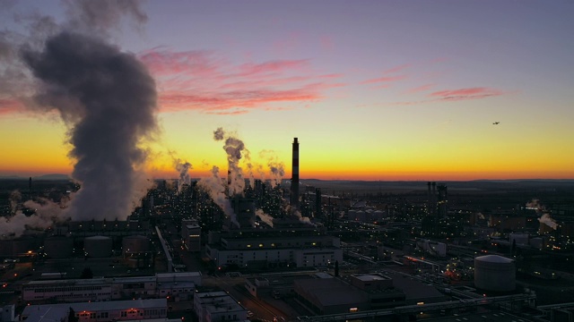 黄昏时分，炼油厂上空升起浓烟，飞机视频素材