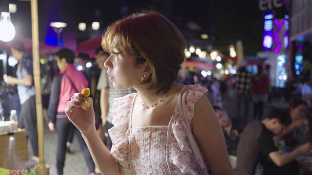 年轻的亚洲女人尝试街头食物，泰国视频素材