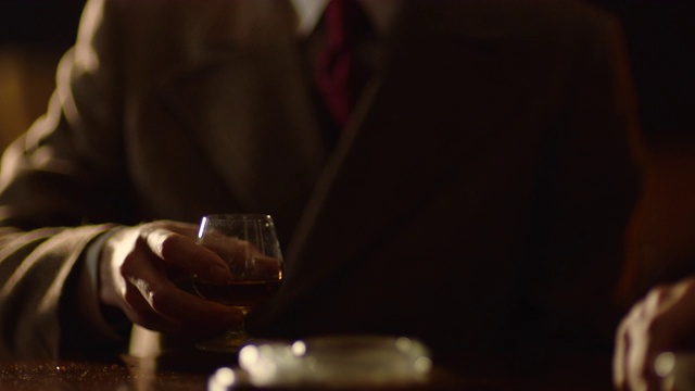 中等镜头的男人围着桌子喝着威士忌欢呼视频下载